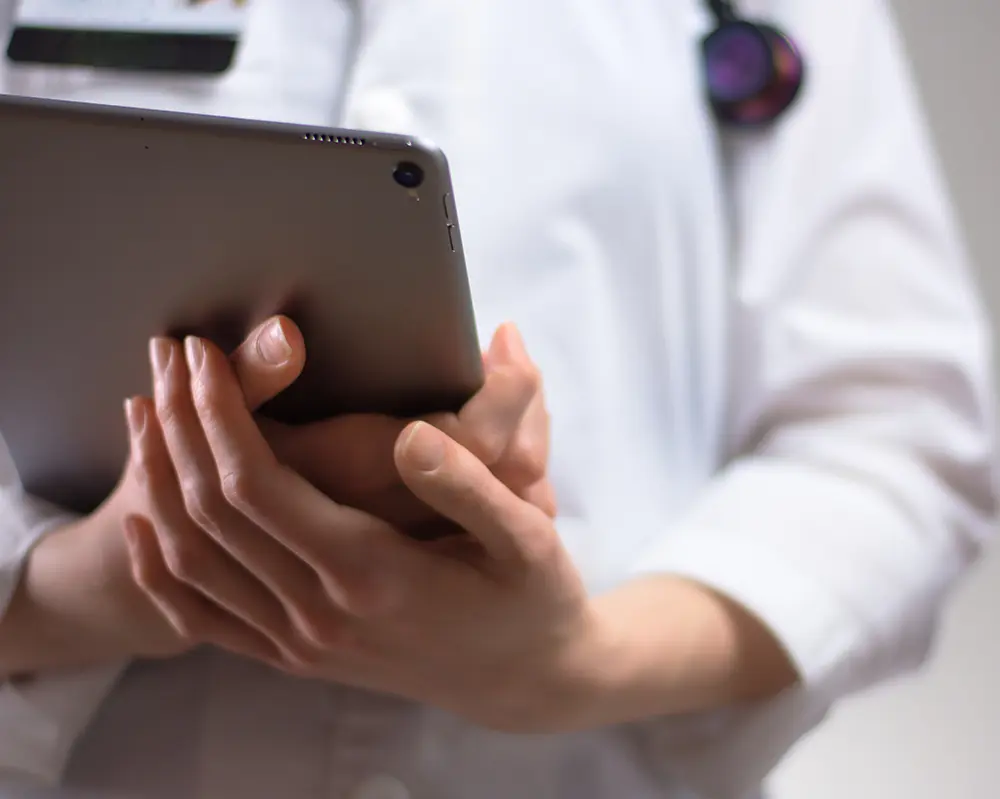 Medical professional holding paperwork